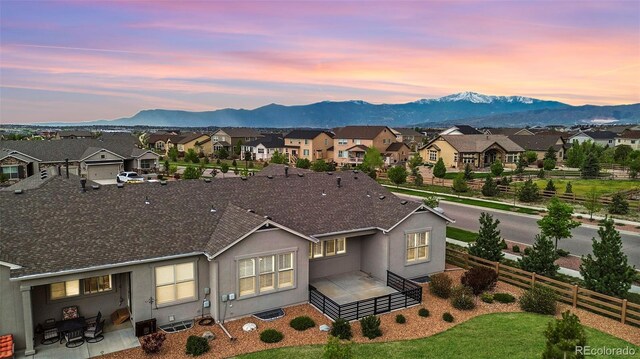 aerial view at dusk featuring a mountain view