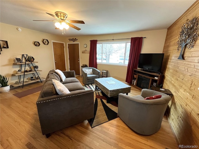 living room with a ceiling fan and wood finished floors