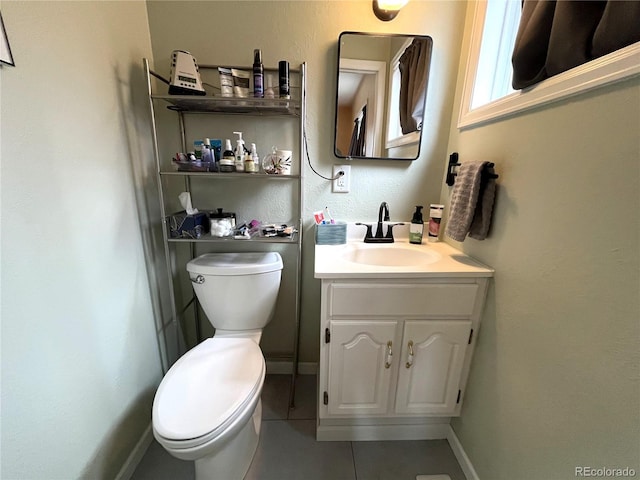 bathroom featuring tile patterned floors, vanity, toilet, and baseboards