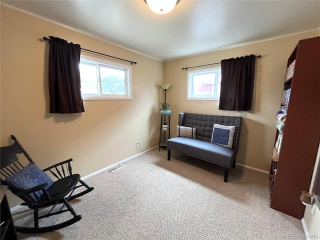 living area featuring plenty of natural light, visible vents, and baseboards