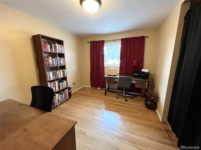 office space featuring baseboards and wood finished floors