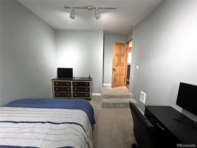 bedroom featuring carpet floors, rail lighting, ceiling fan, and baseboards