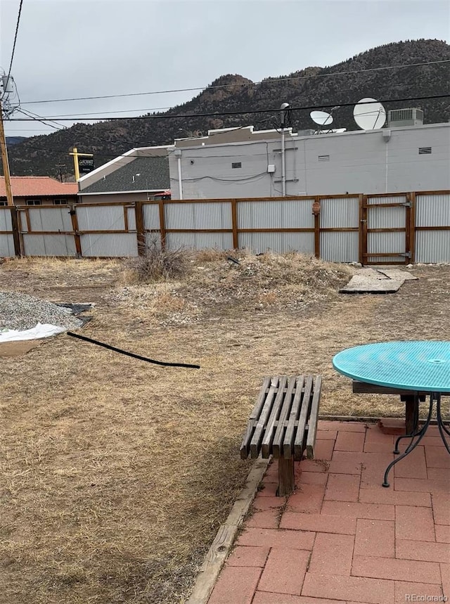 view of yard featuring fence and a mountain view