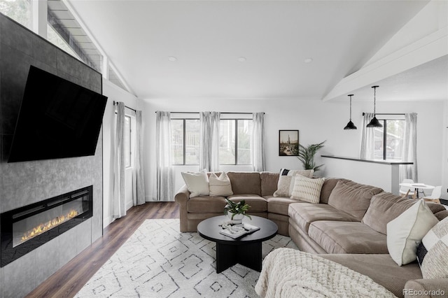 10250 W 33rd Ave, Wheat Ridge, CO 80033 - living area featuring vaulted ceiling, a fireplace, and wood finished floors