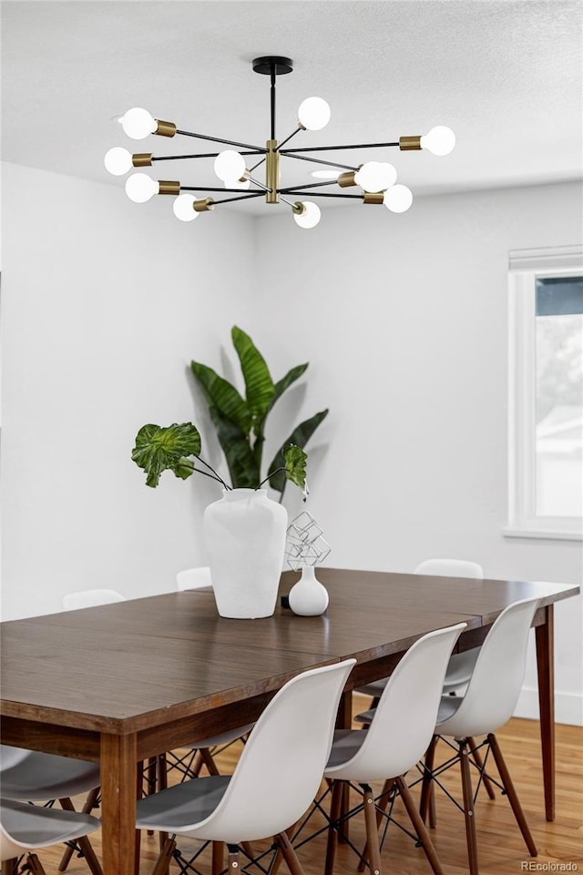 10250 W 33rd Ave, Wheat Ridge, CO 80033 - dining room with a chandelier and light wood finished floors