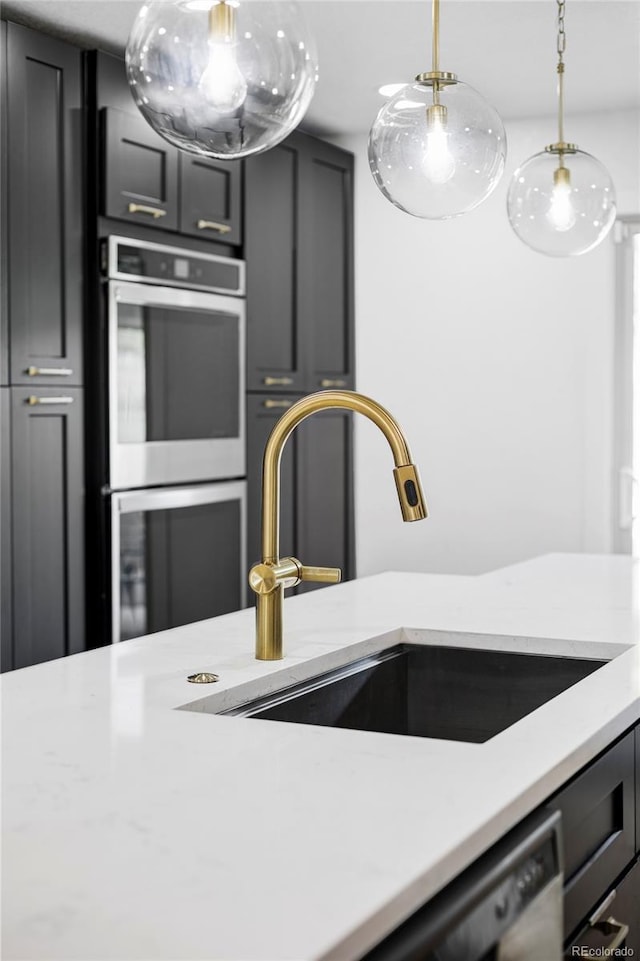 10250 W 33rd Ave, Wheat Ridge, CO 80033 - kitchen featuring appliances with stainless steel finishes, pendant lighting, and light stone countertops
