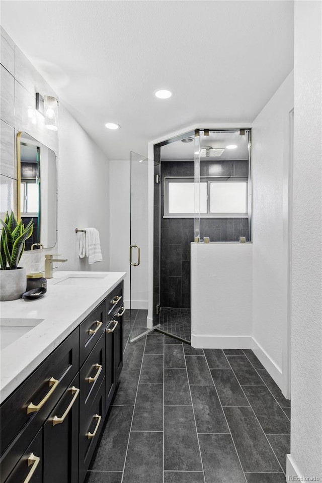 10250 W 33rd Ave, Wheat Ridge, CO 80033 - full bath with double vanity, tiled shower, plenty of natural light, recessed lighting, and tile patterned flooring