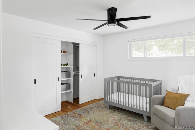 10250 W 33rd Ave, Wheat Ridge, CO 80033 - bedroom featuring a closet, wood finished floors, a crib, and a ceiling fan