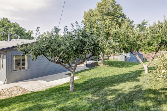 10250 W 33rd Ave, Wheat Ridge, CO 80033 - view of green lawn featuring a storage unit, a patio area, and an outdoor living space