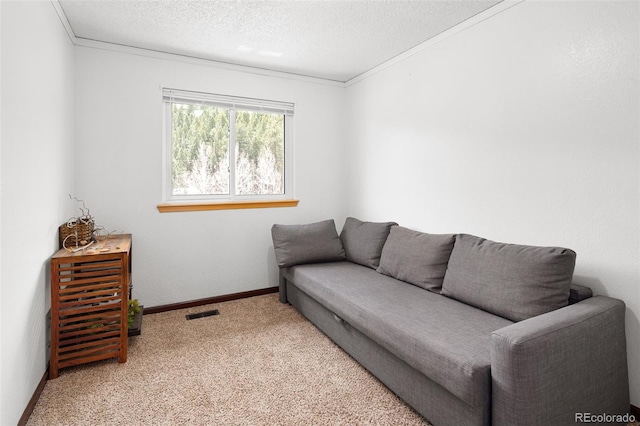 carpeted living area featuring crown molding, a textured ceiling, visible vents, and baseboards