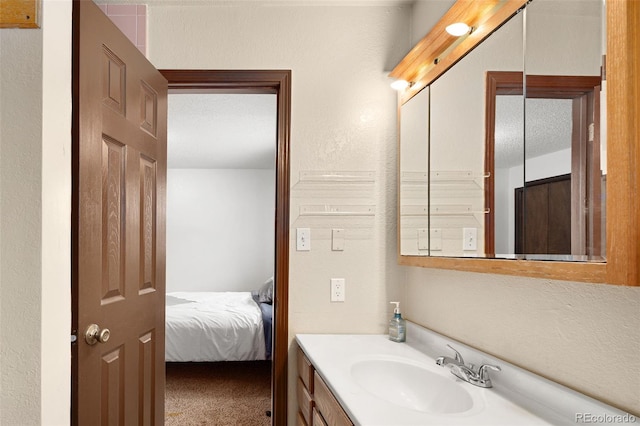 bathroom with vanity and ensuite bath