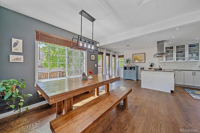 dining area with dark wood-type flooring, recessed lighting, and baseboards