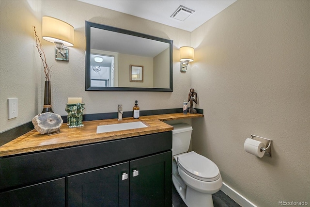 bathroom featuring toilet and vanity