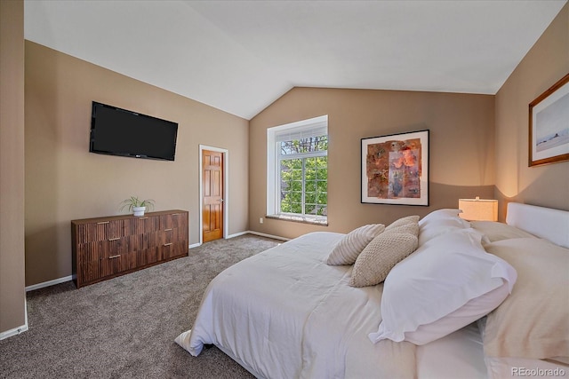 bedroom with carpet flooring, vaulted ceiling, and baseboards