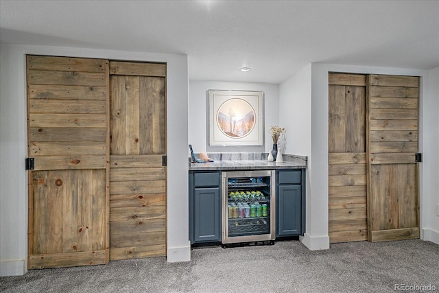 indoor dry bar with wine cooler, light colored carpet, baseboards, and recessed lighting