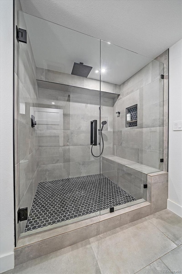 full bath featuring a stall shower, baseboards, tile patterned flooring, and recessed lighting