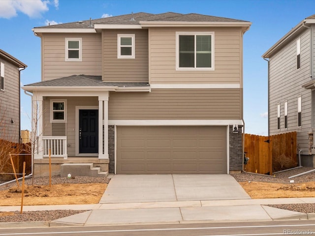 view of front of home featuring a garage, a shingled roof, driveway, and fence