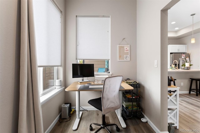 office space with a healthy amount of sunlight and wood-type flooring