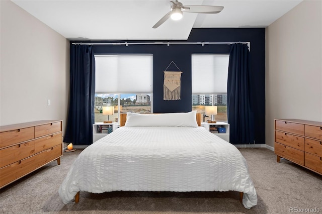 bedroom with ceiling fan and light carpet