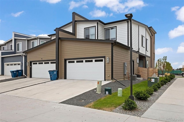 view of front of property with central AC unit and a garage