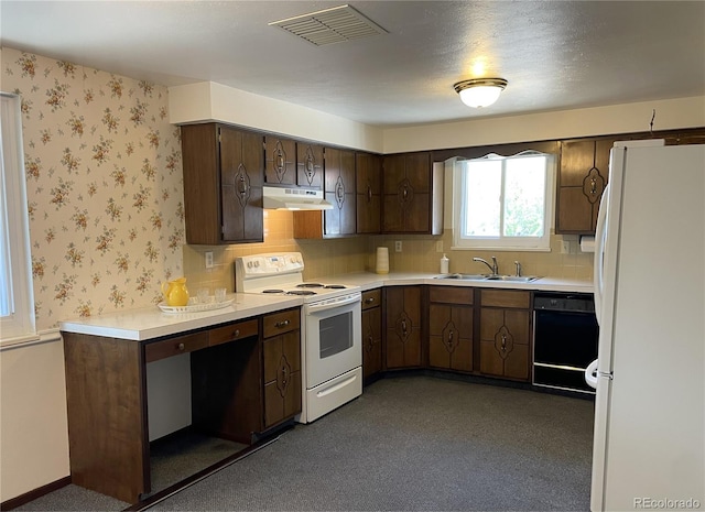 kitchen with white appliances, under cabinet range hood, a sink, light countertops, and dark brown cabinets
