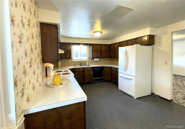 kitchen featuring white appliances, light countertops, a sink, dark brown cabinetry, and wallpapered walls