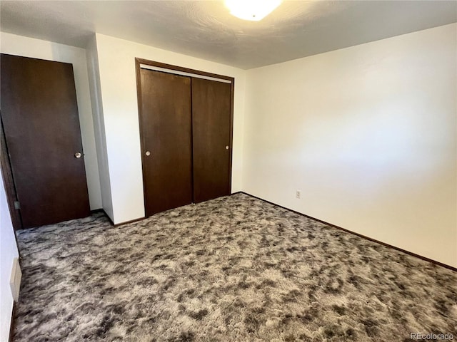 unfurnished bedroom with carpet floors and a closet