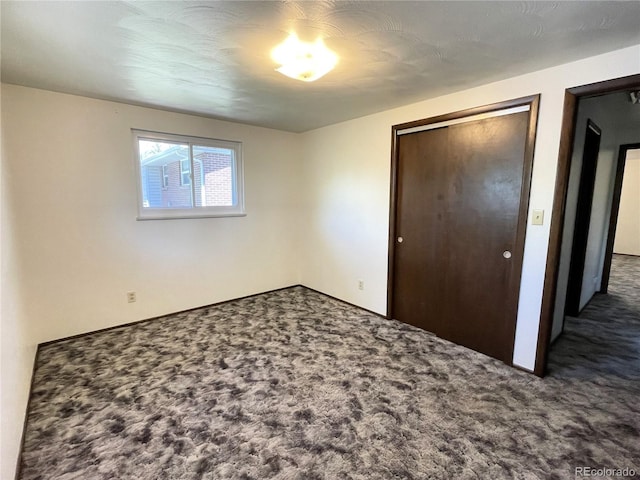 unfurnished bedroom featuring carpet floors and a closet