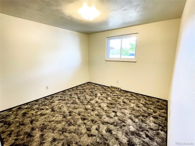 carpeted empty room with baseboards