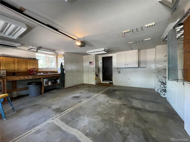 garage with a garage door opener and a workshop area