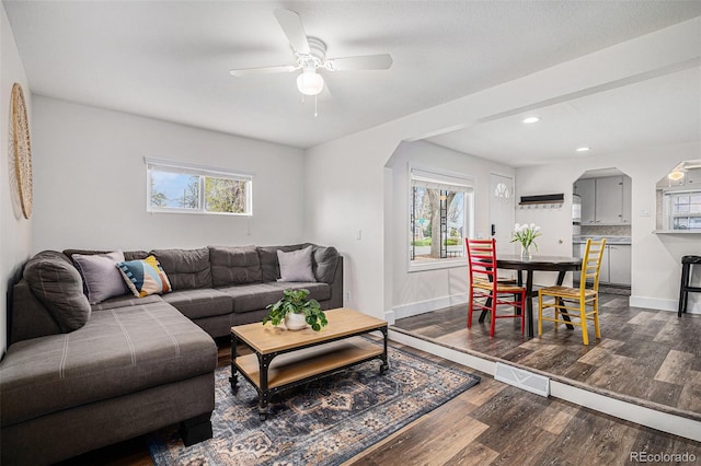 1293 S Perry St, Denver, CO 80219 - living room featuring arched walkways, wood finished floors, ceiling fan, and recessed lighting