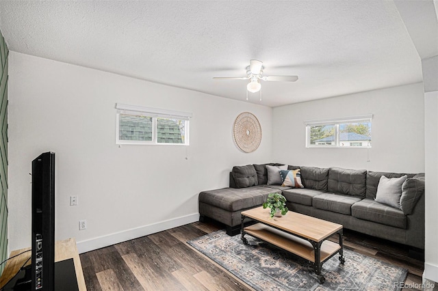 1293 S Perry St, Denver, CO 80219 - living room featuring plenty of natural light, a ceiling fan, dark wood-type flooring, and a textured ceiling
