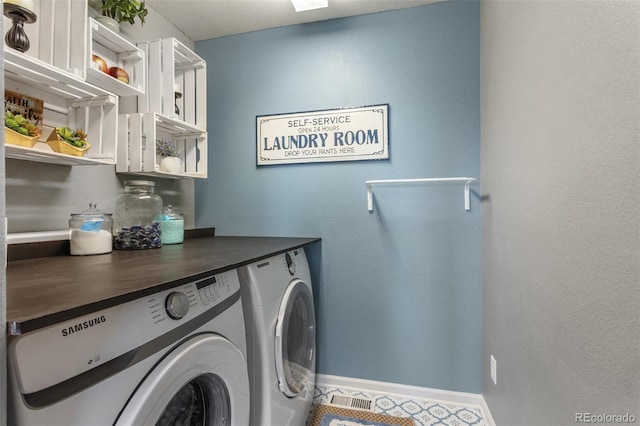 laundry room featuring laundry area, baseboards, and separate washer and dryer