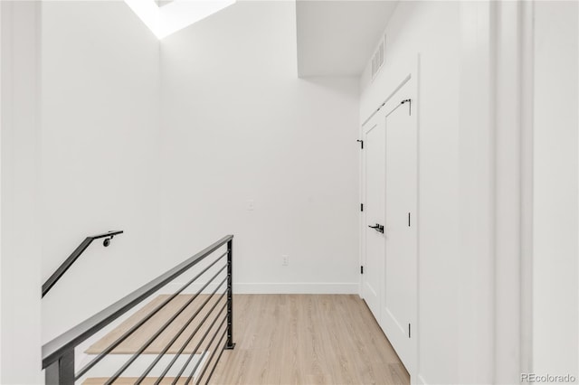 corridor with light hardwood / wood-style flooring