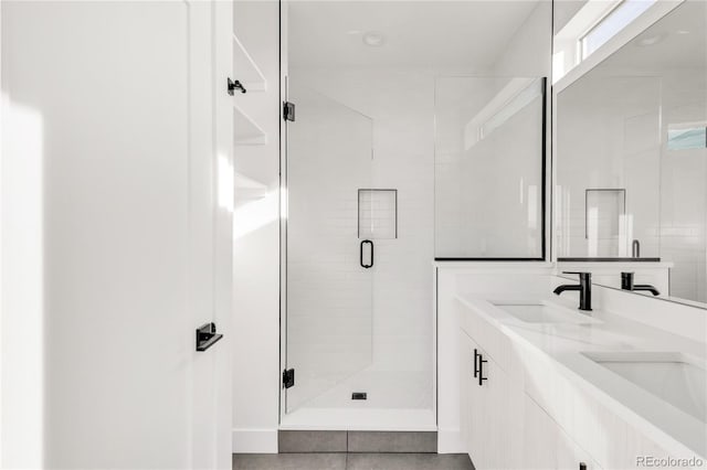 bathroom featuring vanity and a shower with shower door