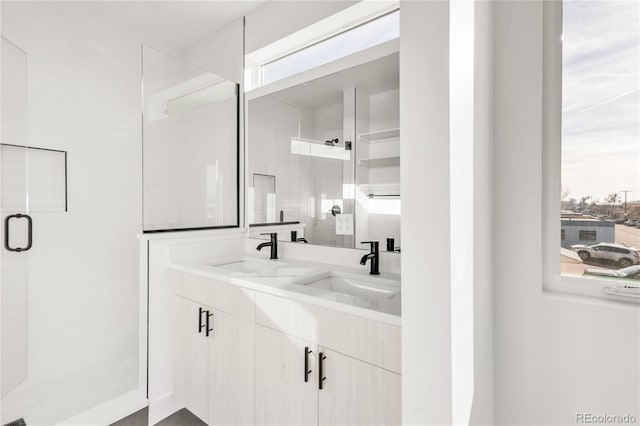 bathroom featuring vanity and a shower with door