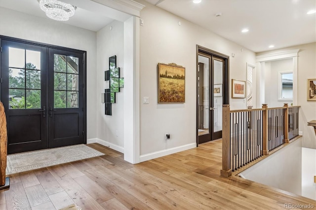 entrance foyer featuring recessed lighting, french doors, baseboards, and light wood finished floors