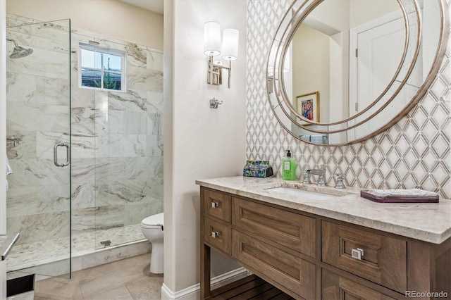 bathroom featuring decorative backsplash, toilet, vanity, and a marble finish shower