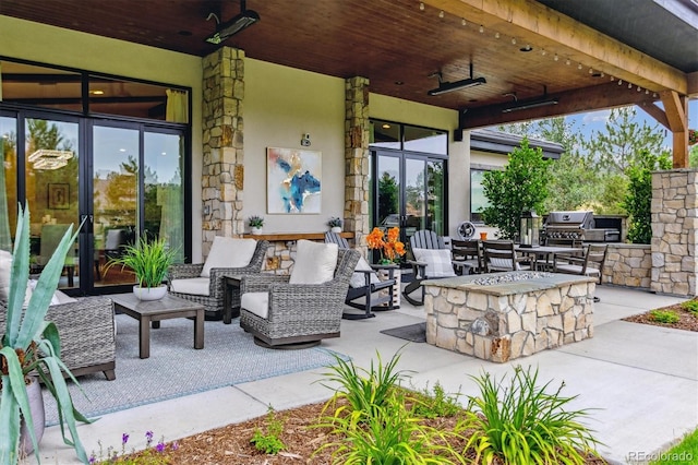 view of patio / terrace with an outdoor living space with a fire pit, ceiling fan, and grilling area