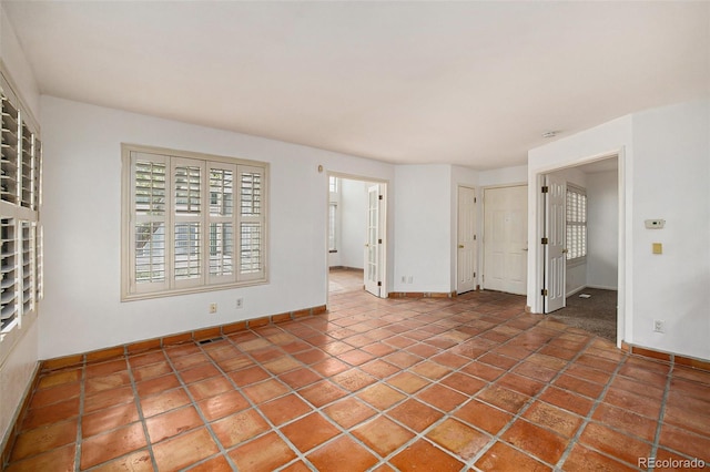 empty room with tile floors