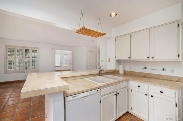 kitchen featuring white cabinetry, kitchen peninsula, tile flooring, sink, and dishwasher