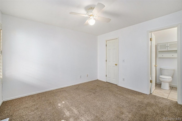 unfurnished bedroom featuring carpet flooring, a closet, connected bathroom, and ceiling fan