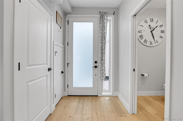 entrance foyer featuring baseboards and light wood finished floors