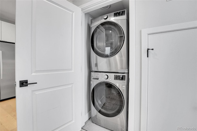 laundry area with stacked washer and dryer and laundry area