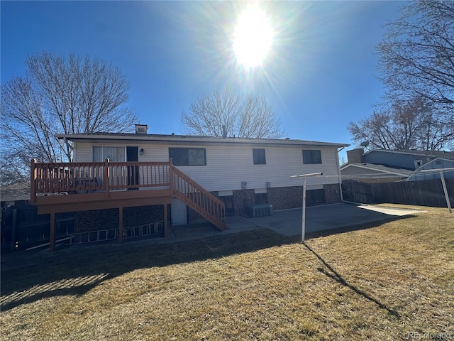 rear view of house with a lawn, a deck, fence, stairway, and a patio area