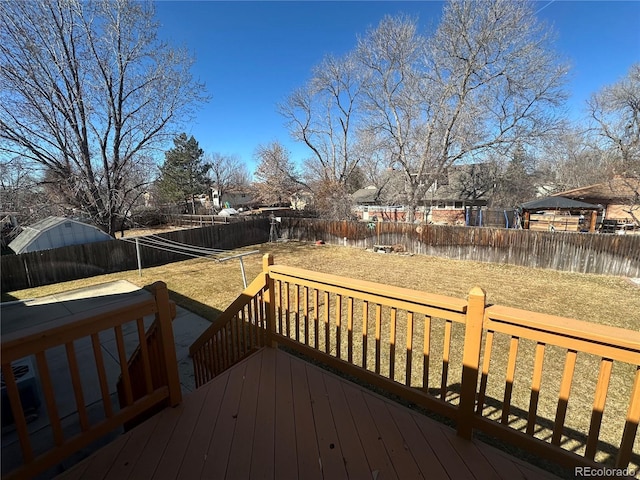 wooden deck featuring a fenced backyard