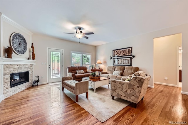 21107 Hawthorne Ln, Parker, CO 80138 - living area with a ceiling fan, light wood-type flooring, and a stone fireplace