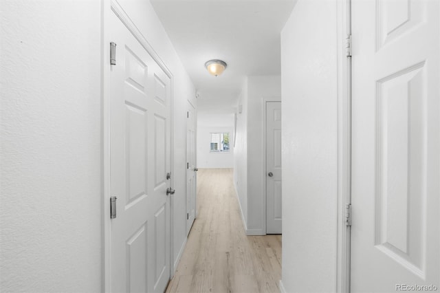 hallway with light wood-type flooring