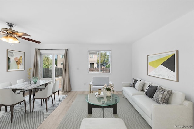 living room featuring ceiling fan and light wood-type flooring