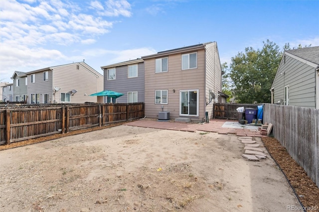 back of house with central air condition unit and a patio